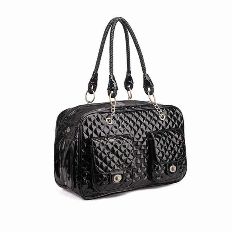 A black quilted patent leather pet carrier with two braided shoulder straps, silver-tone hardware, and snap-button front pockets, shown on a plain white background.