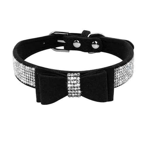 Black dog collar with a bow and crystal embellishments on a white background