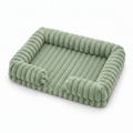 Sage green ribbed corduroy rectangular pet sofa bed with raised bolster sides, shown at a 3/4 angle on a white background