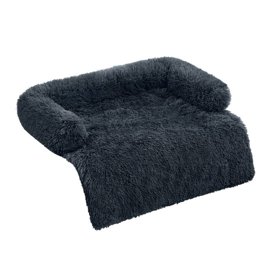 Dark charcoal grey long shaggy faux fur sofa cover protector with raised bolster back and sides and a flat front drape panel, shown at a 3/4 angle on a white background