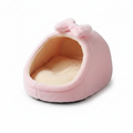 Soft pink plush igloo cat bed with fluffy bow detail and cream fleece interior, white background