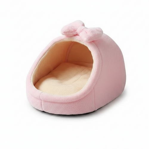 Soft pink plush igloo cat bed with fluffy bow detail and cream fleece interior, white background