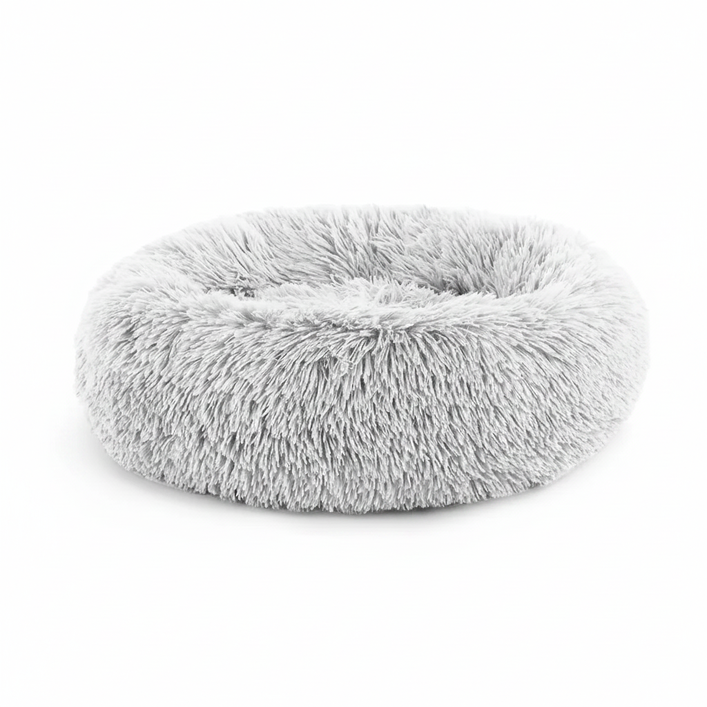 Light grey round donut pet bed with long shaggy faux fur and a deep cushioned center, shown at a slight angle on a white background