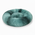 Round teal ombré shaggy faux fur donut calming pet bed three-quarter view on white background