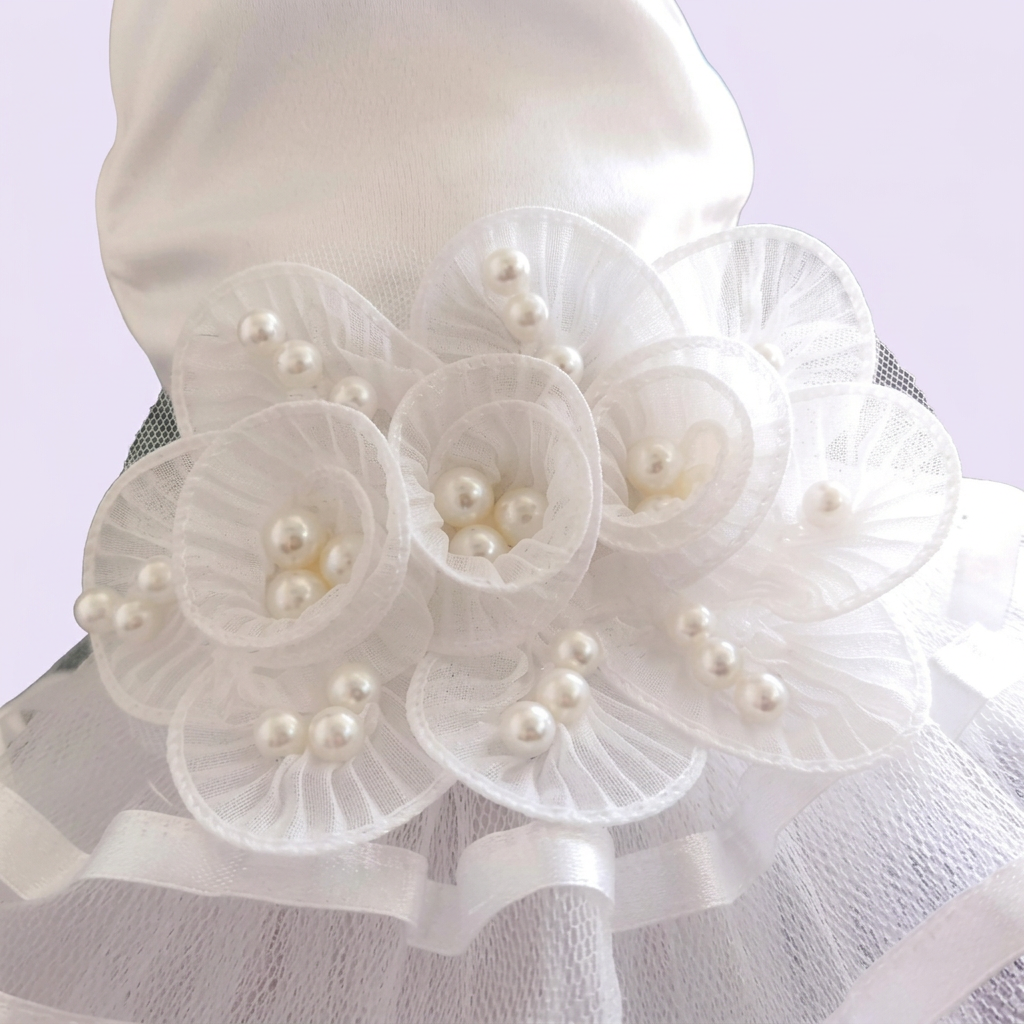 White floral dress close-up against a very light lavender background
