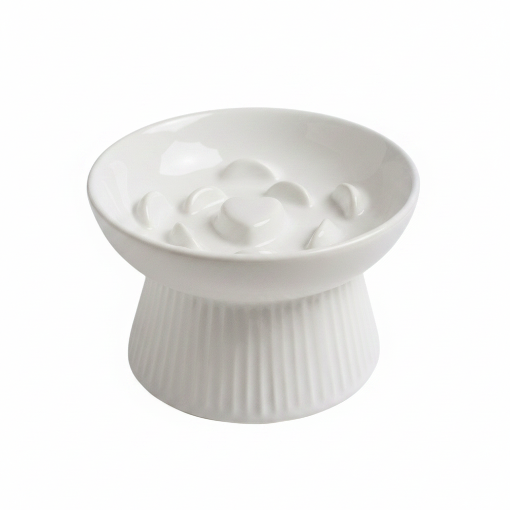 White ceramic raised slow feeder cat bowl with ribbed pedestal base and heart-center ridge pattern, white background