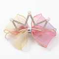 Yellow and pink crown bow hair clip on white