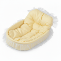 Pastel yellow gingham oval pet bed with tufted bolster backrest and sheer white lace ruffle trim, angled product shot on white background
