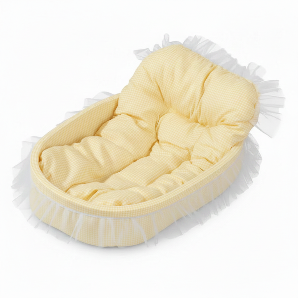 Pastel yellow gingham oval pet bed with tufted bolster backrest and sheer white lace ruffle trim, angled product shot on white background