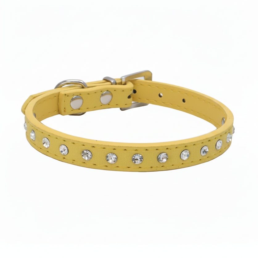 Yellow leather cat and dog collar with single row clear rhinestone crystals and silver buckle, angled side view luxury bling pet collar product photo on white background