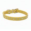 Yellow leather cat and dog collar with single row clear rhinestone crystals and silver buckle, angled side view luxury bling pet collar product photo on white background